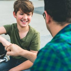 Junge und Mann begrüßen sich freundlich